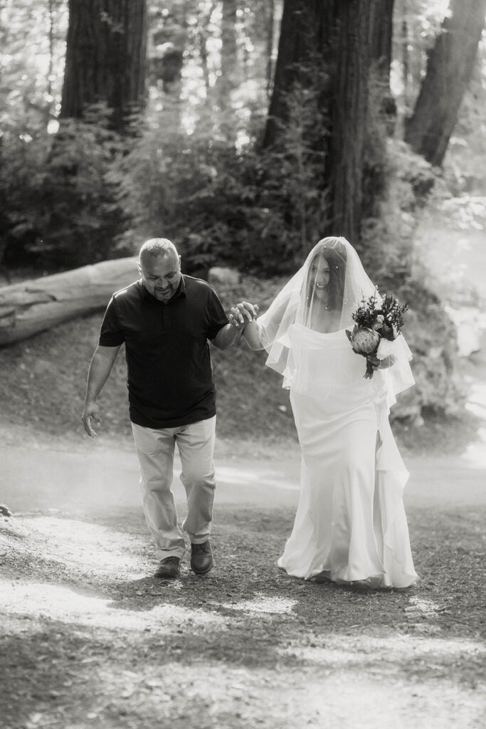 A person helping their child walk up a hill to their wedding