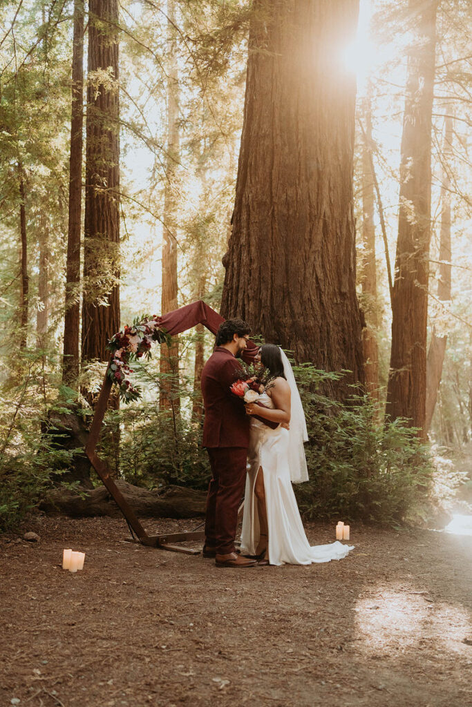 Newlyweds with their arms around each other during their intimate elopement outdoors 