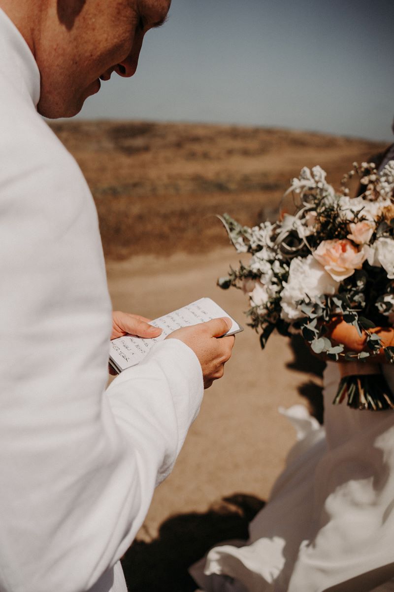 A man reading his vows at his wedding ceremony